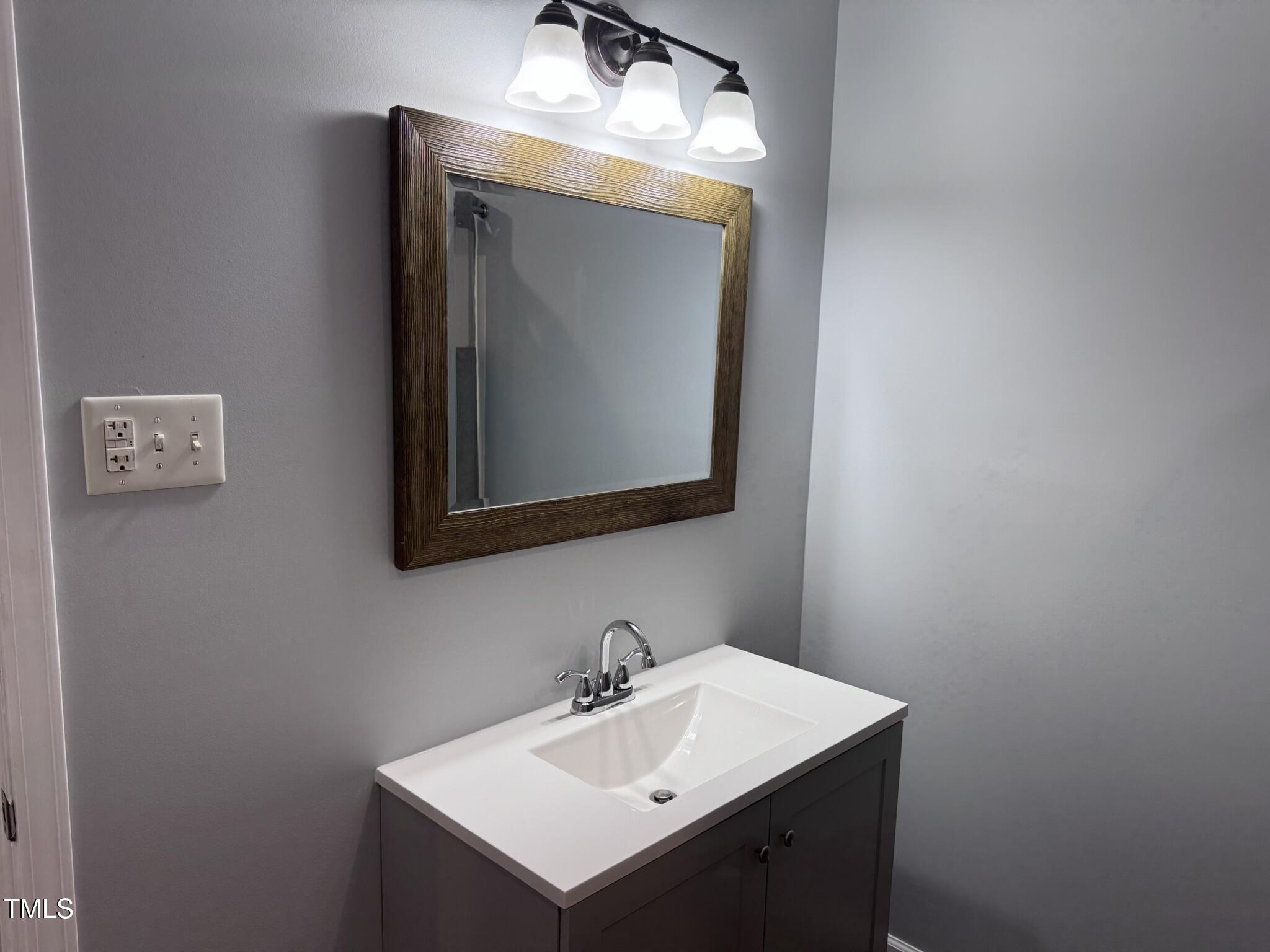 6740 Guess Road Hillsborough, NC 27278 - Photo 11 of 17 a bathroom with a sink vanity and a mirror