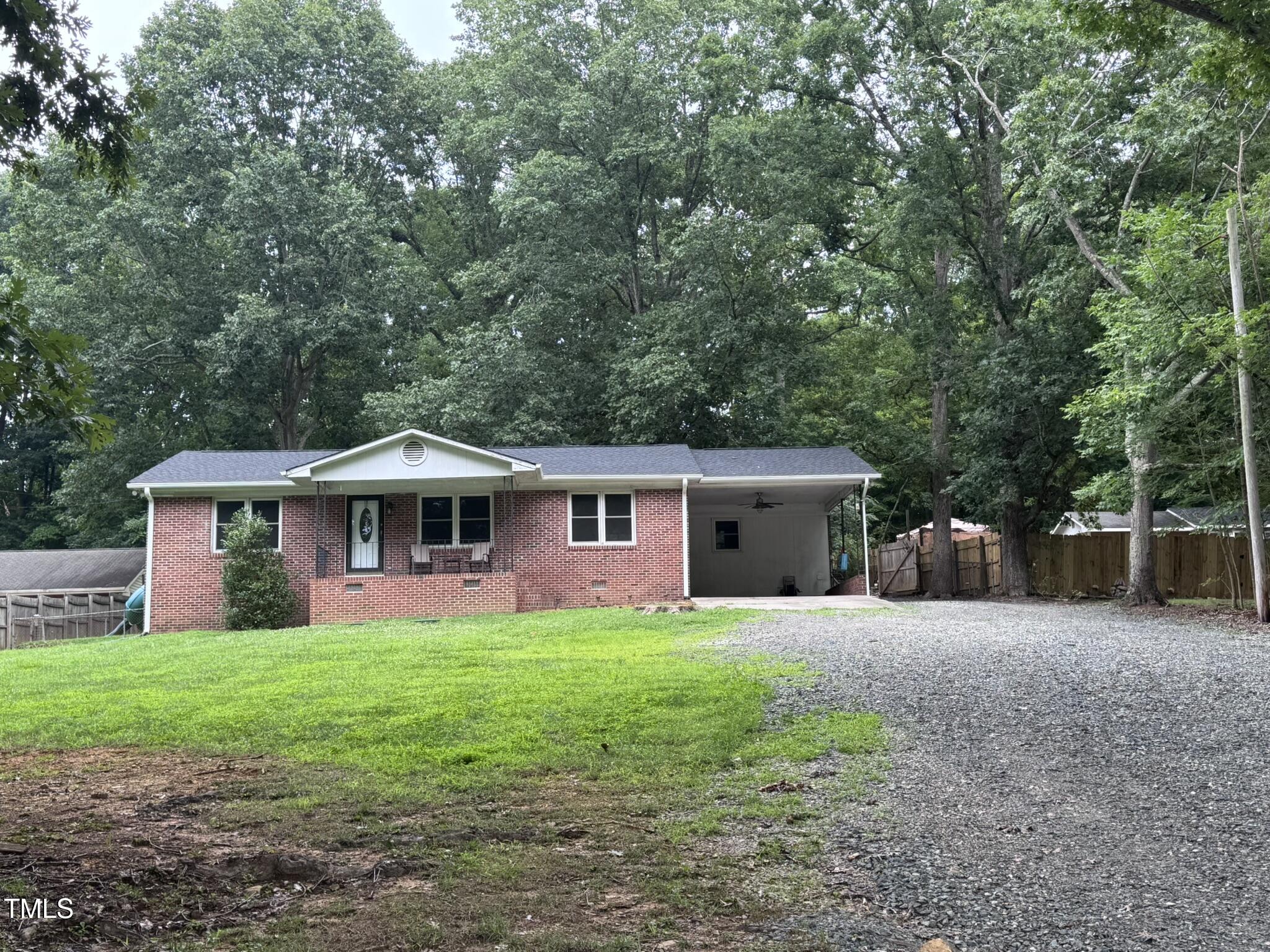 6740 Guess Road Hillsborough, NC 27278 - Photo 2 of 17 a front view of a house with yard and green space