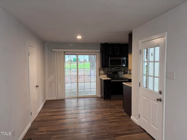 a view of a kitchen with a sink and a window