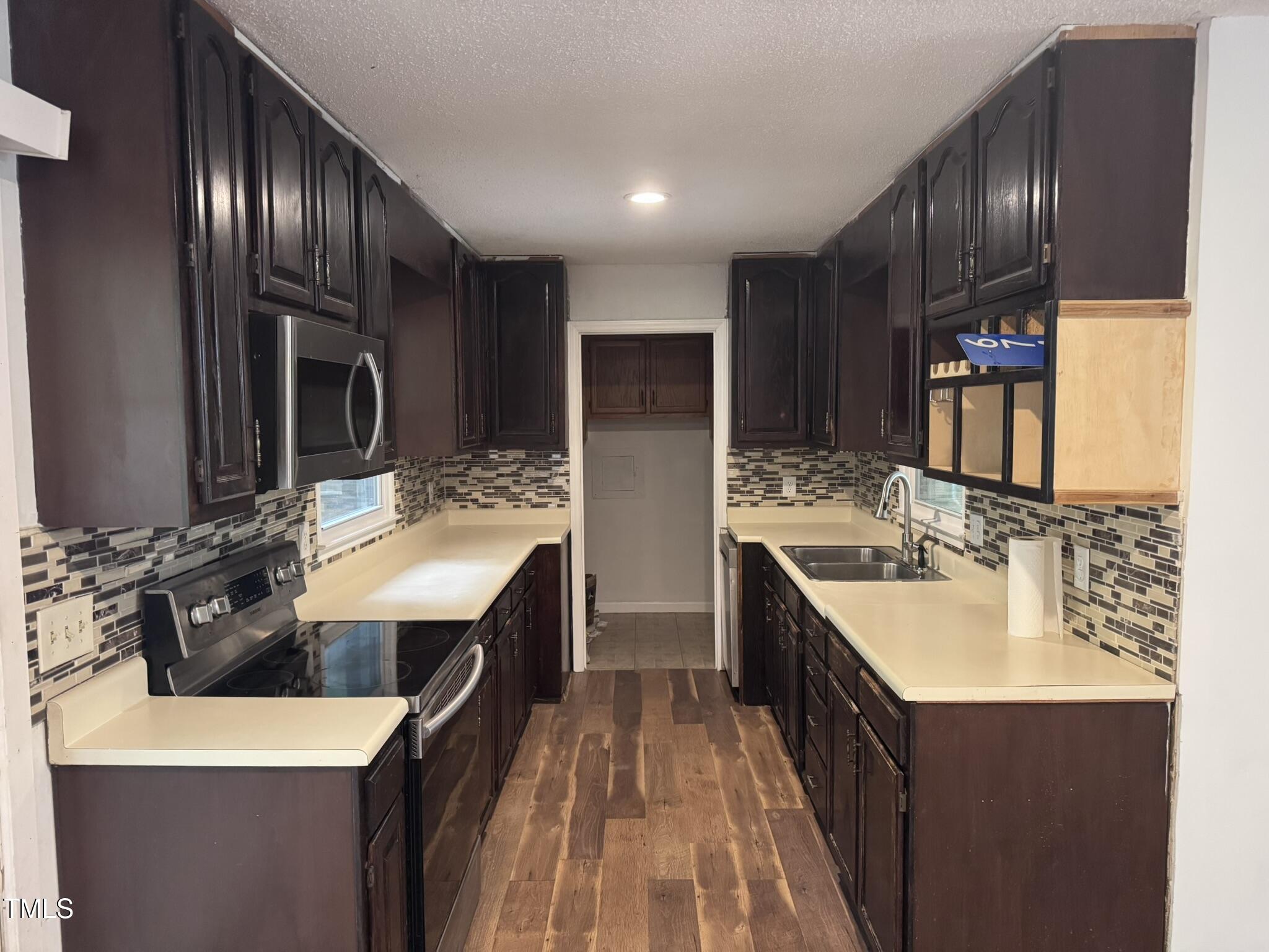 6740 Guess Road Hillsborough, NC 27278 - Photo 7 of 17 a kitchen with a sink stove and refrigerator