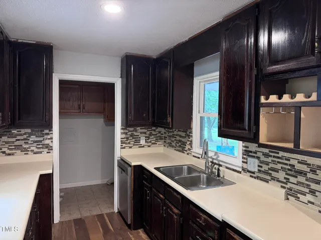 a bathroom with double vanity and a mirror