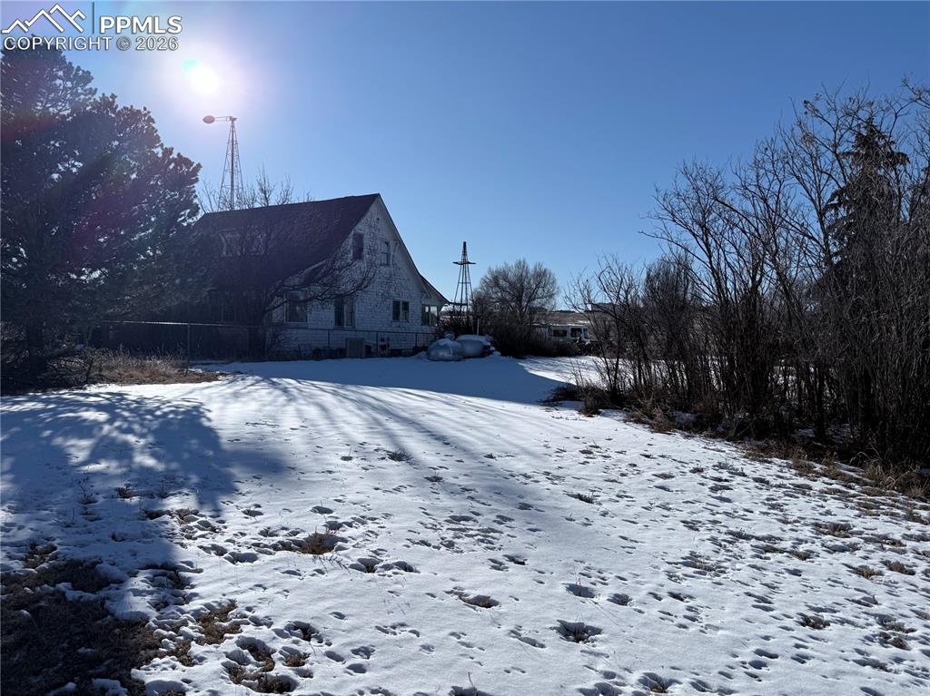 3380 Curtis Road Peyton, CO 80831 - Photo 3 of 6 a wooden bench sitting in middle of the ground
