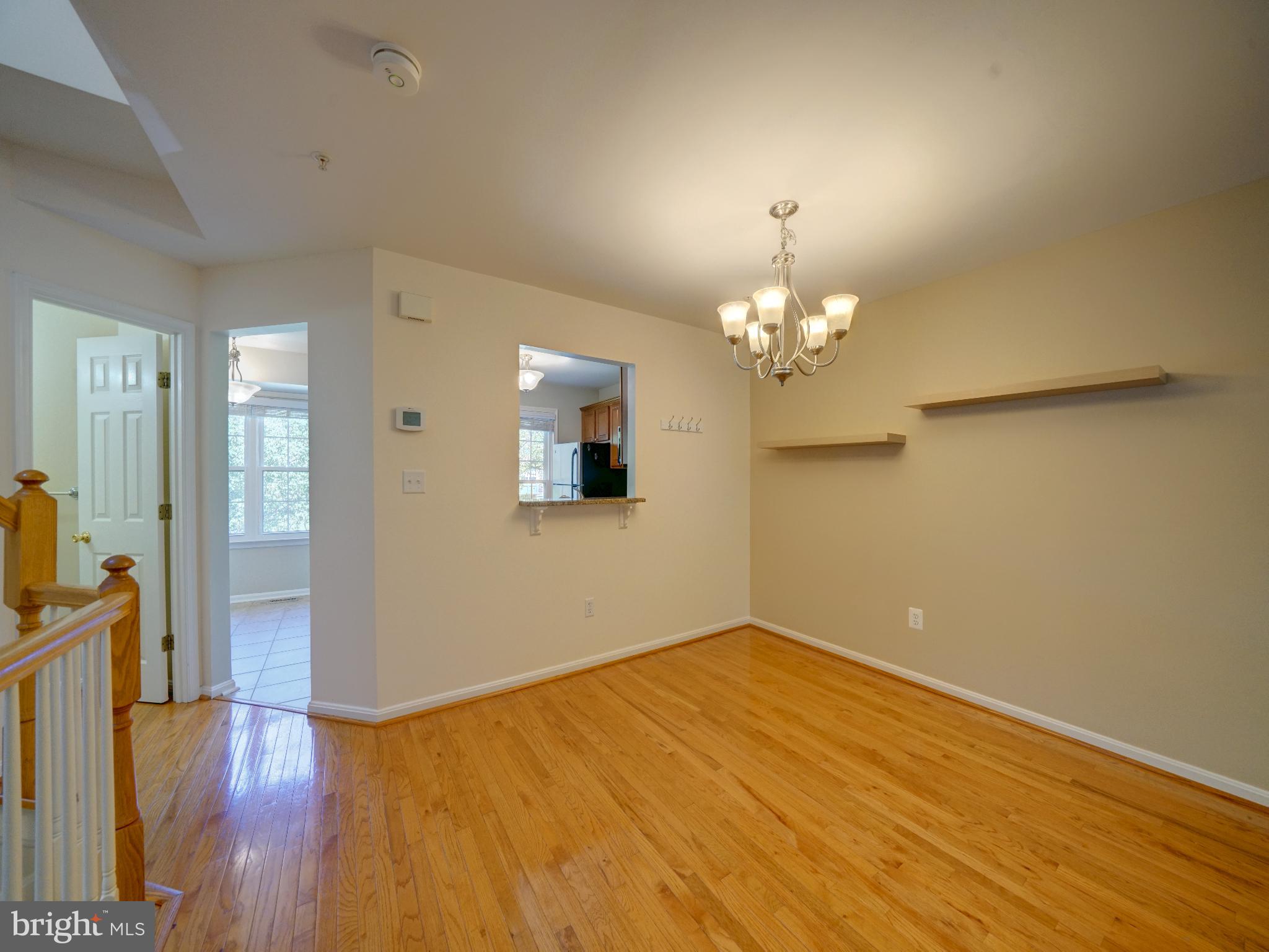 2238 Commissary Circle Odenton, MD 21113 - Photo 13 of 48 a view of a room with wooden floor and chandelier