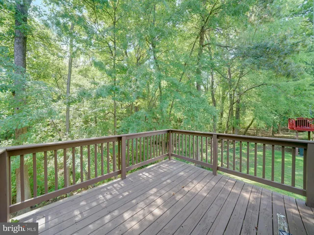 a balcony with wooden floor and fence