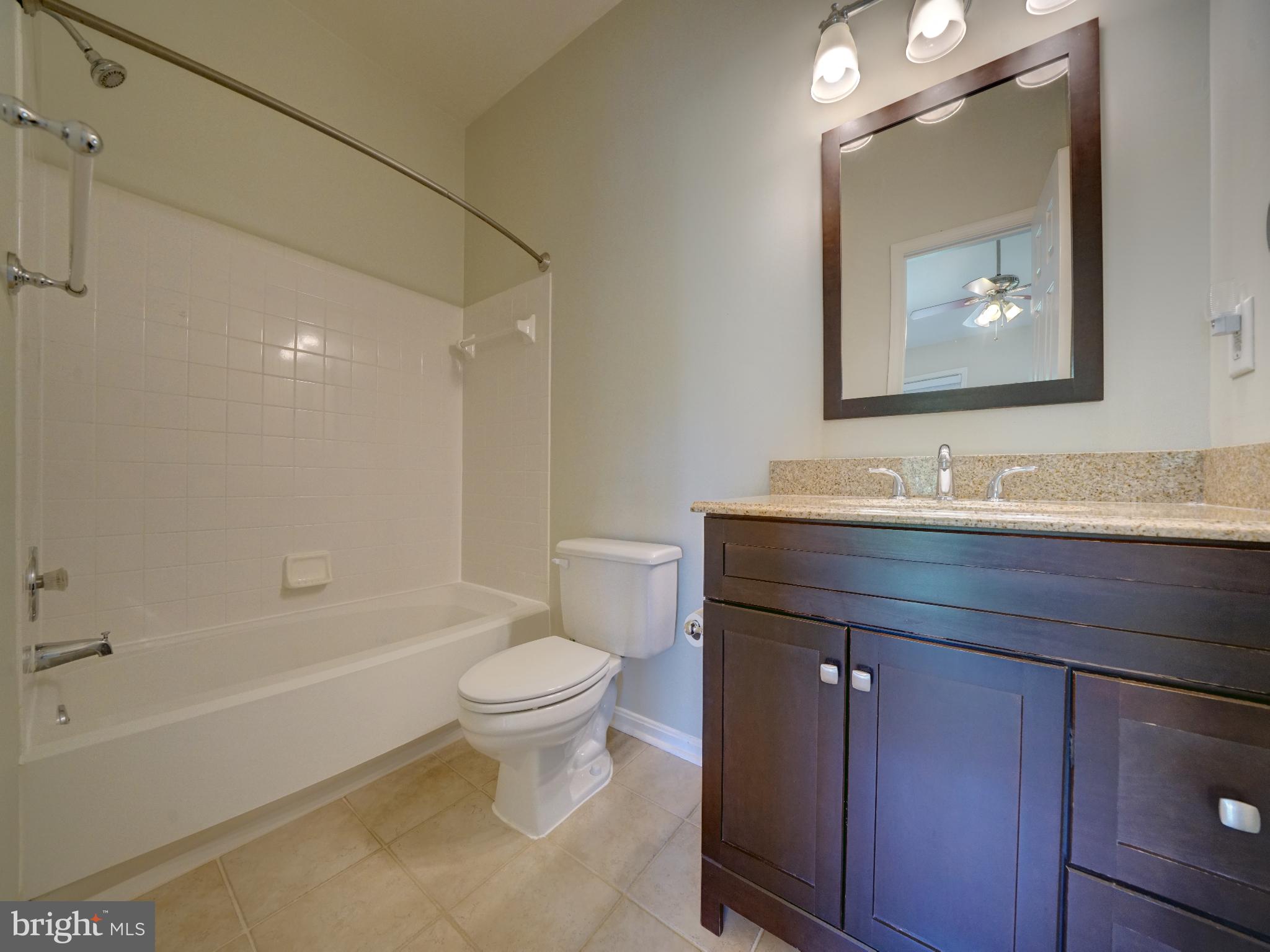 2238 Commissary Circle Odenton, MD 21113 - Photo 21 of 48 a bathroom with a granite countertop toilet a sink and bathtub