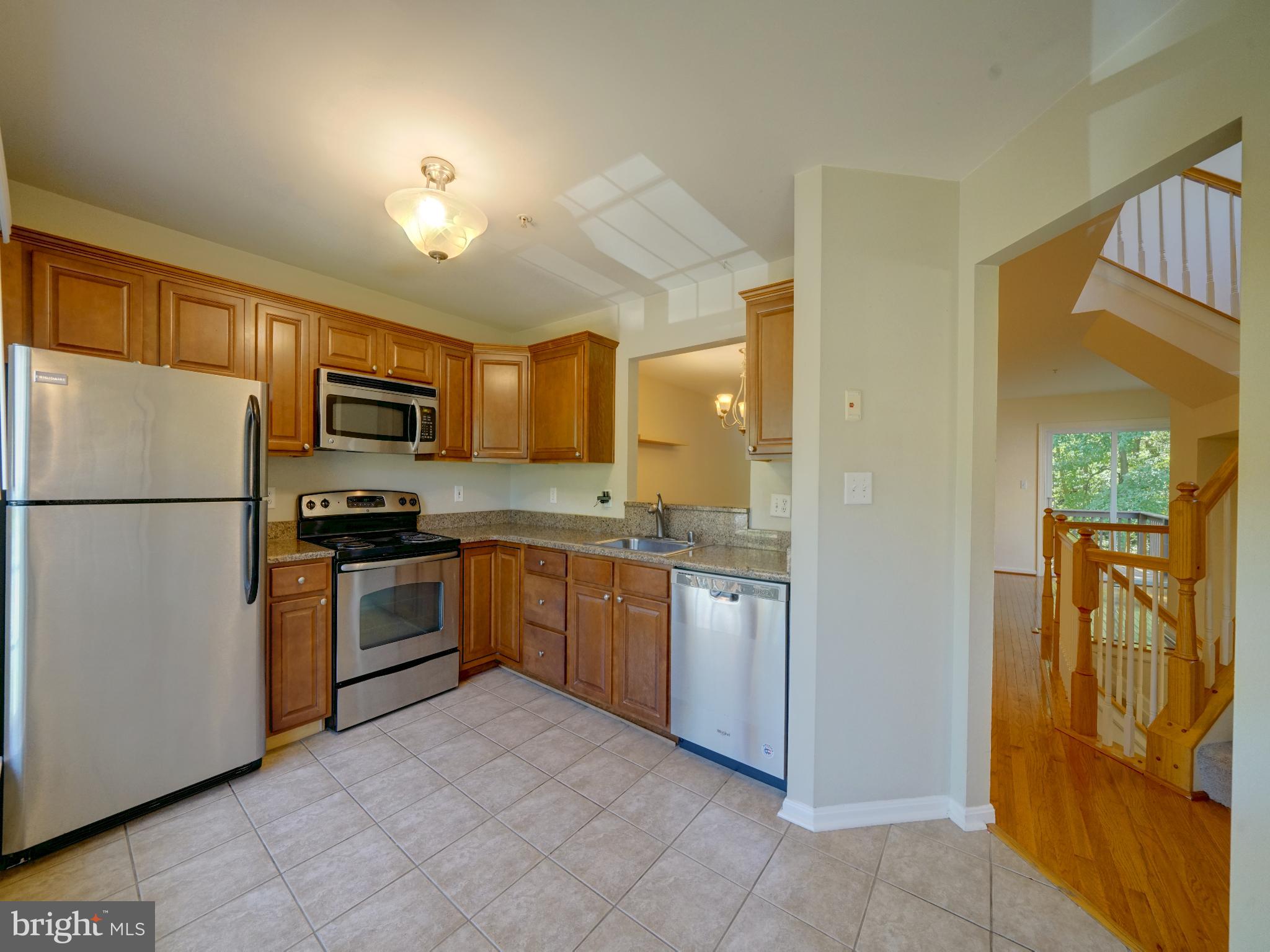 2238 Commissary Circle Odenton, MD 21113 - Photo 3 of 48 a kitchen with granite countertop stainless steel appliances and refrigerator