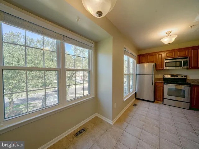 a kitchen with granite countertop a refrigerator and a stove