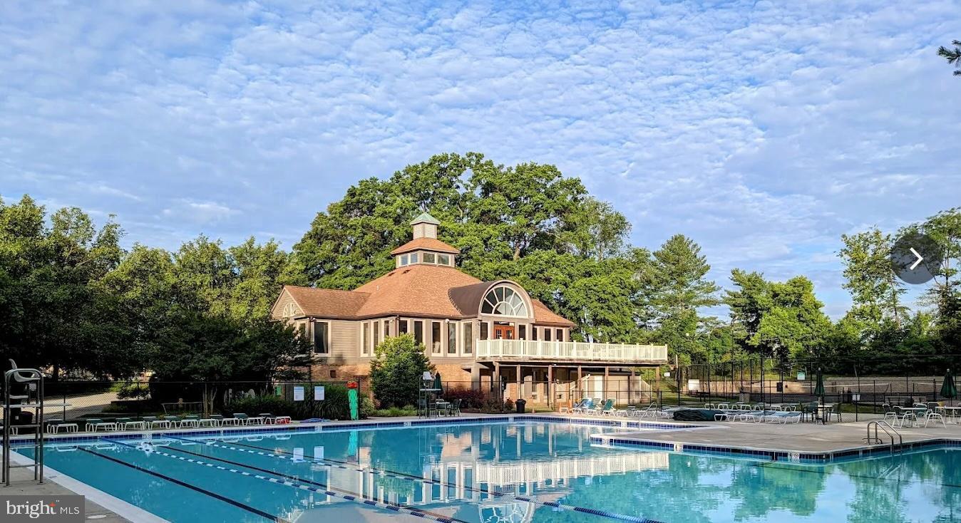2238 Commissary Circle Odenton, MD 21113 - Photo 42 of 48 a front view of a building with garden and trees