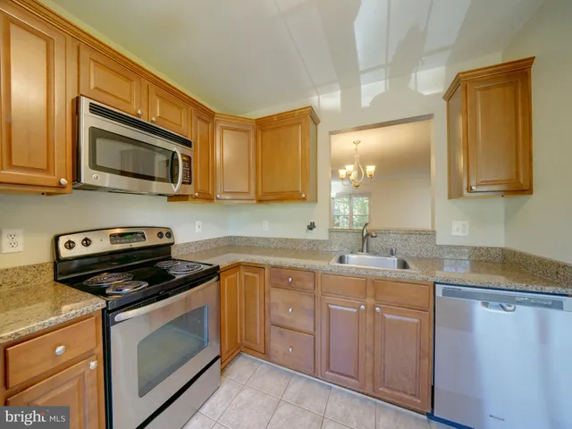 a kitchen with a sink stove and microwave