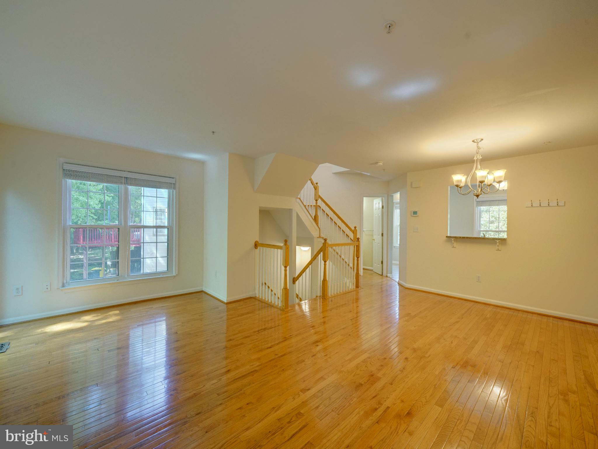 2238 Commissary Circle Odenton, MD 21113 - Photo 7 of 48 a view of an empty room with wooden floor and a window