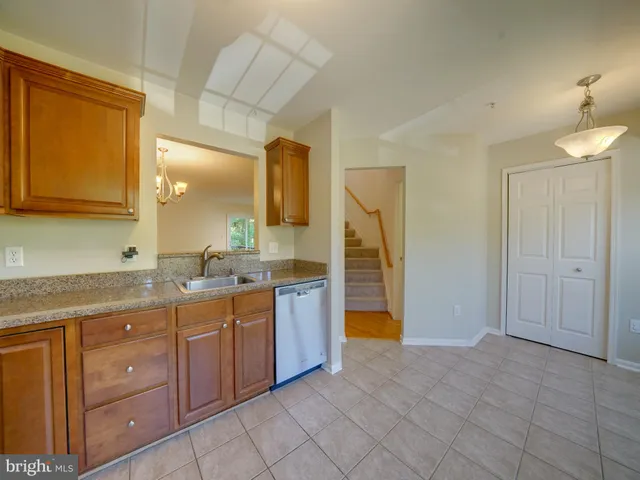a spacious bathroom with a granite countertop sink and a mirror