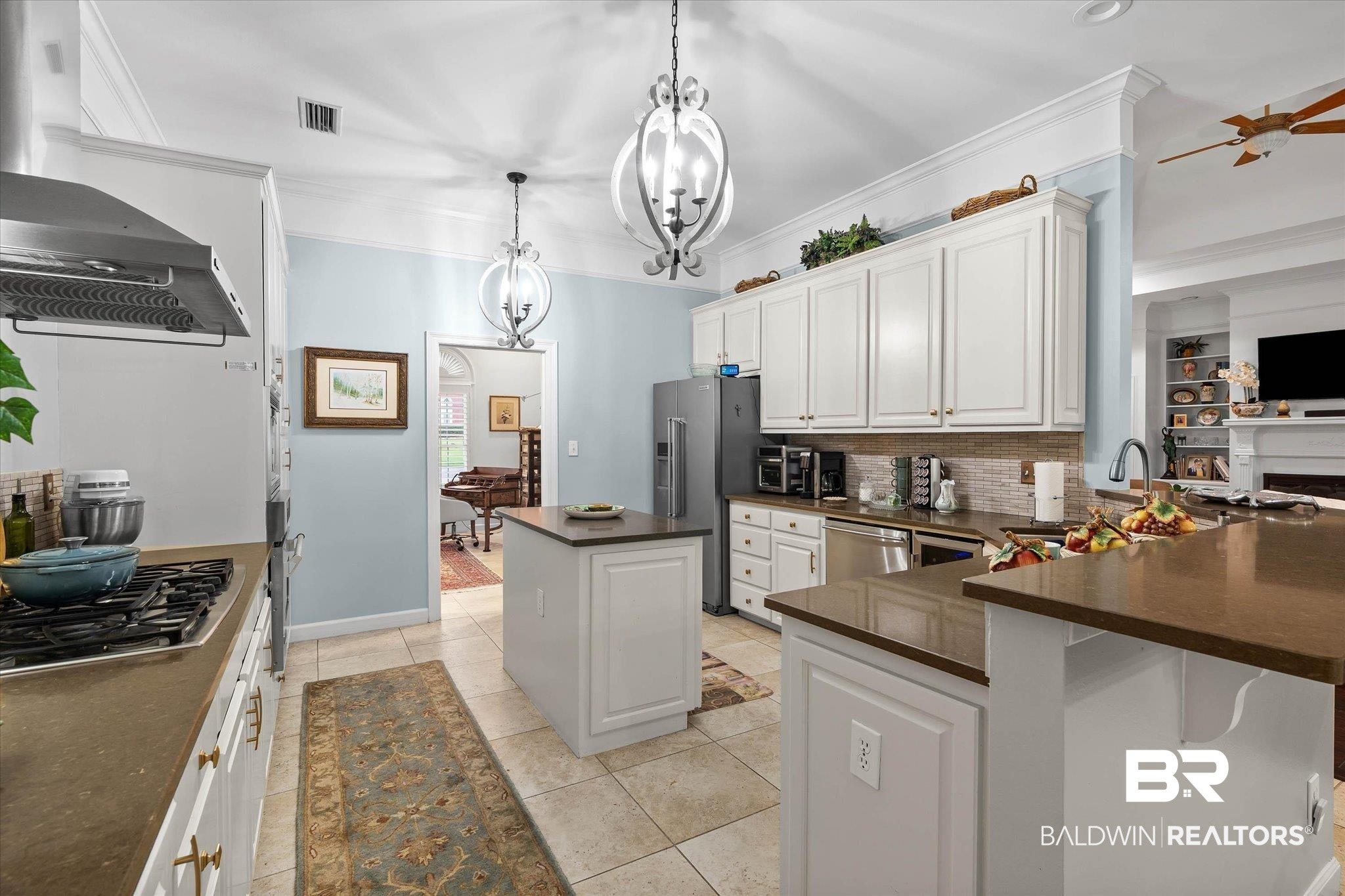 136 Old Mill Road Fairhope, AL 36532 - Photo 7 of 36 Kitchen featuring white cabinetry, light-toned tile flooring, and dark countertops