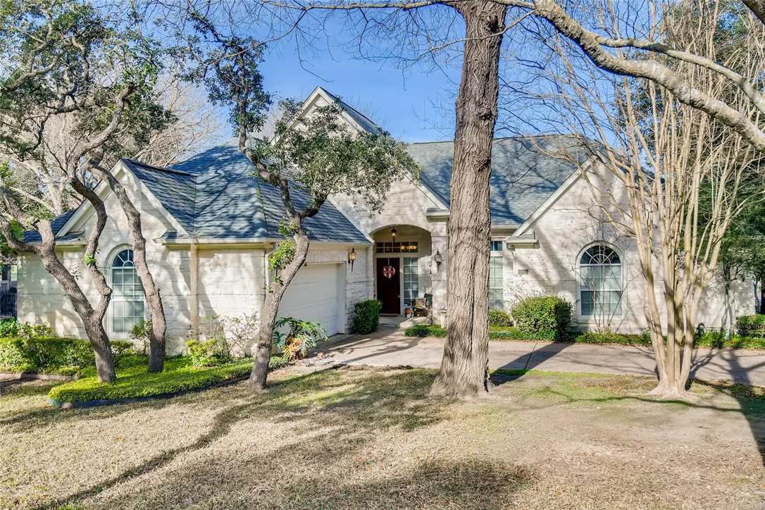 a view of a house with a yard and pathway
