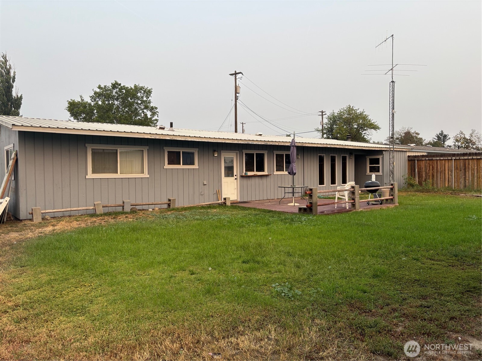 9008 Bong Loop, Unit B Moses Lake, WA 98837 - Photo 2 of 27 a front view of house with yard and outdoor seating