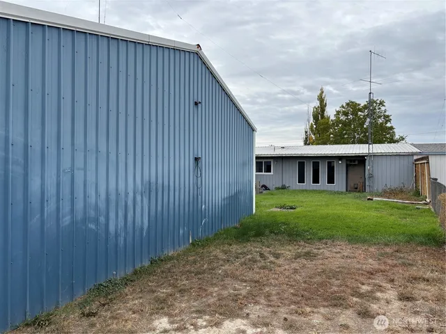 a backyard of a house with lots of green space and lake view