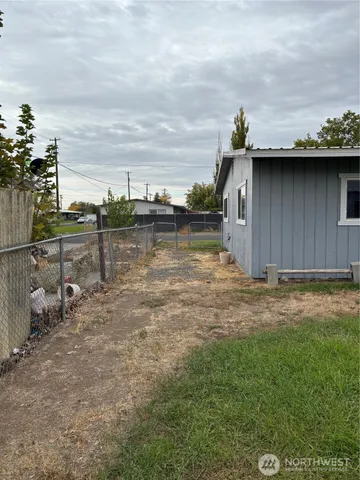 a view of a wooden bridge near a lake
