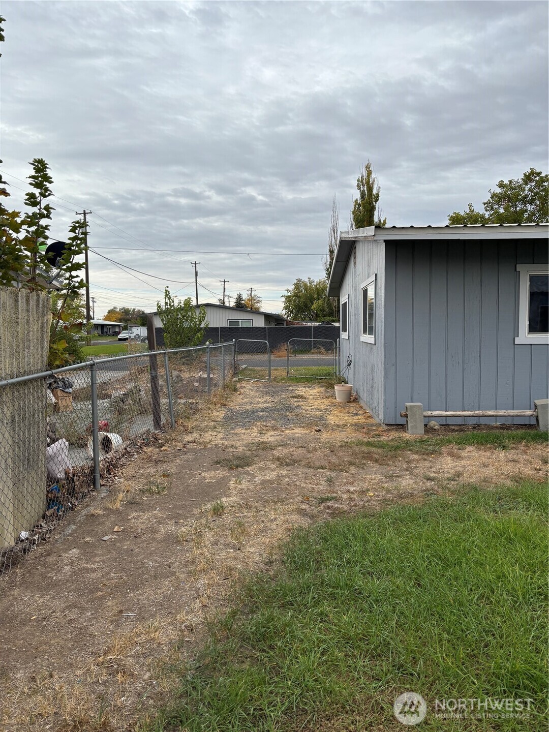 9008 Bong Loop, Unit B Moses Lake, WA 98837 - Photo 26 of 27 a backyard of a house with lots of green space and lake view