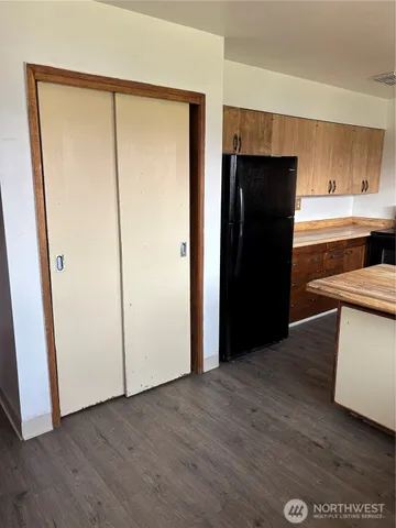 a kitchen with a refrigerator and a stove