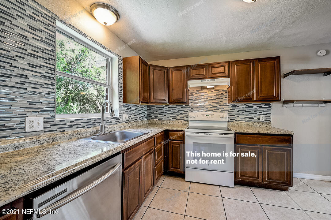 3503 Rogero Road Jacksonville, FL 32277 - Photo 19 of 27 a kitchen with a sink and cabinets