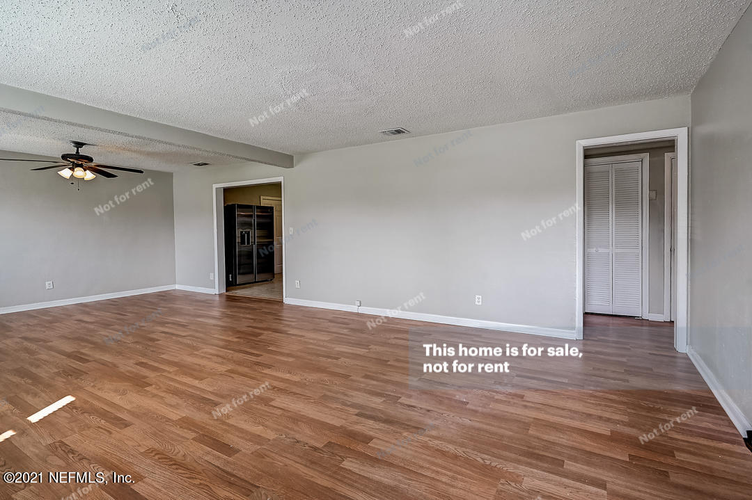 3503 Rogero Road Jacksonville, FL 32277 - Photo 20 of 27 a view of an empty room with wooden floor