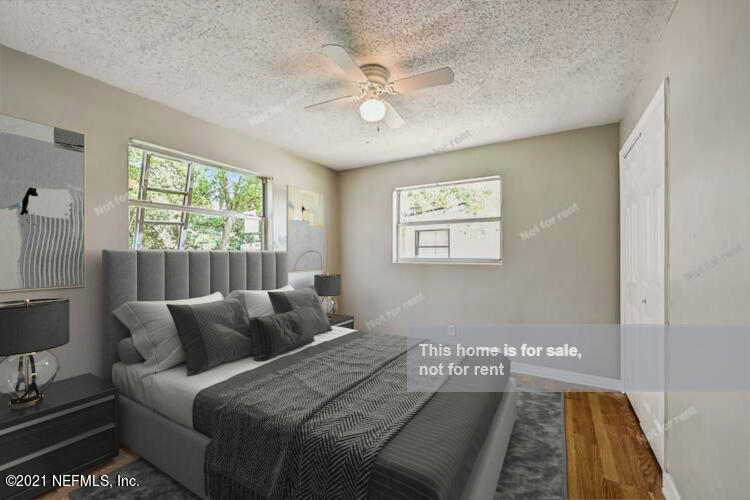 3503 Rogero Road Jacksonville, FL 32277 - Photo 2 of 27 a bedroom with a bed and window