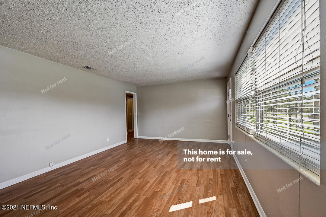3503 Rogero Road Jacksonville, FL 32277 - Photo 21 of 27 a view of a room with wooden floor and a window