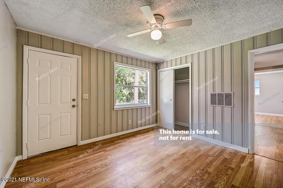 3503 Rogero Road Jacksonville, FL 32277 - Photo 23 of 27 wooden floor in an empty room with a window