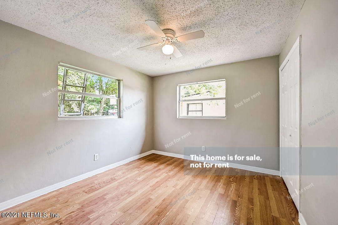 3503 Rogero Road Jacksonville, FL 32277 - Photo 25 of 27 a view of a big room with wooden floor and windows