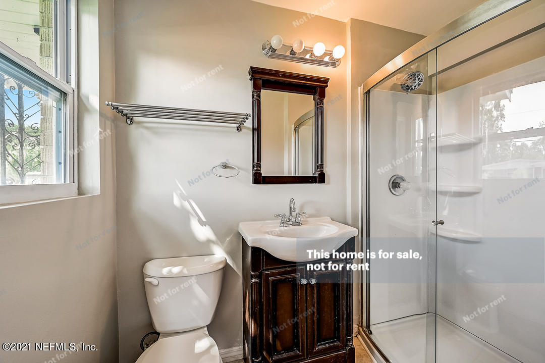 3503 Rogero Road Jacksonville, FL 32277 - Photo 6 of 27 a bathroom with a toilet a sink and a mirror
