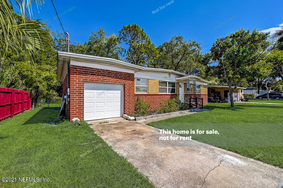 3503 Rogero Road Jacksonville, FL 32277 - Photo 8 of 27 a front view of a house with a yard