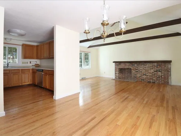 a view of a kitchen with a sink and a fireplace