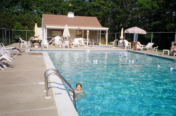 a view of a house with a yard patio and swimming pool