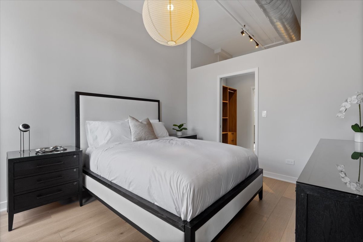 740 West Fulton Street, Unit 507 Chicago, IL 60661 - Photo 13 of 27 a bedroom with a bed and a closet