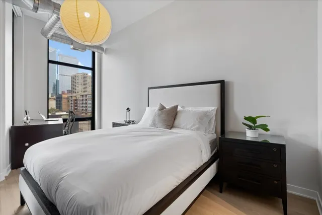 a bedroom with a bed and painting on the wall