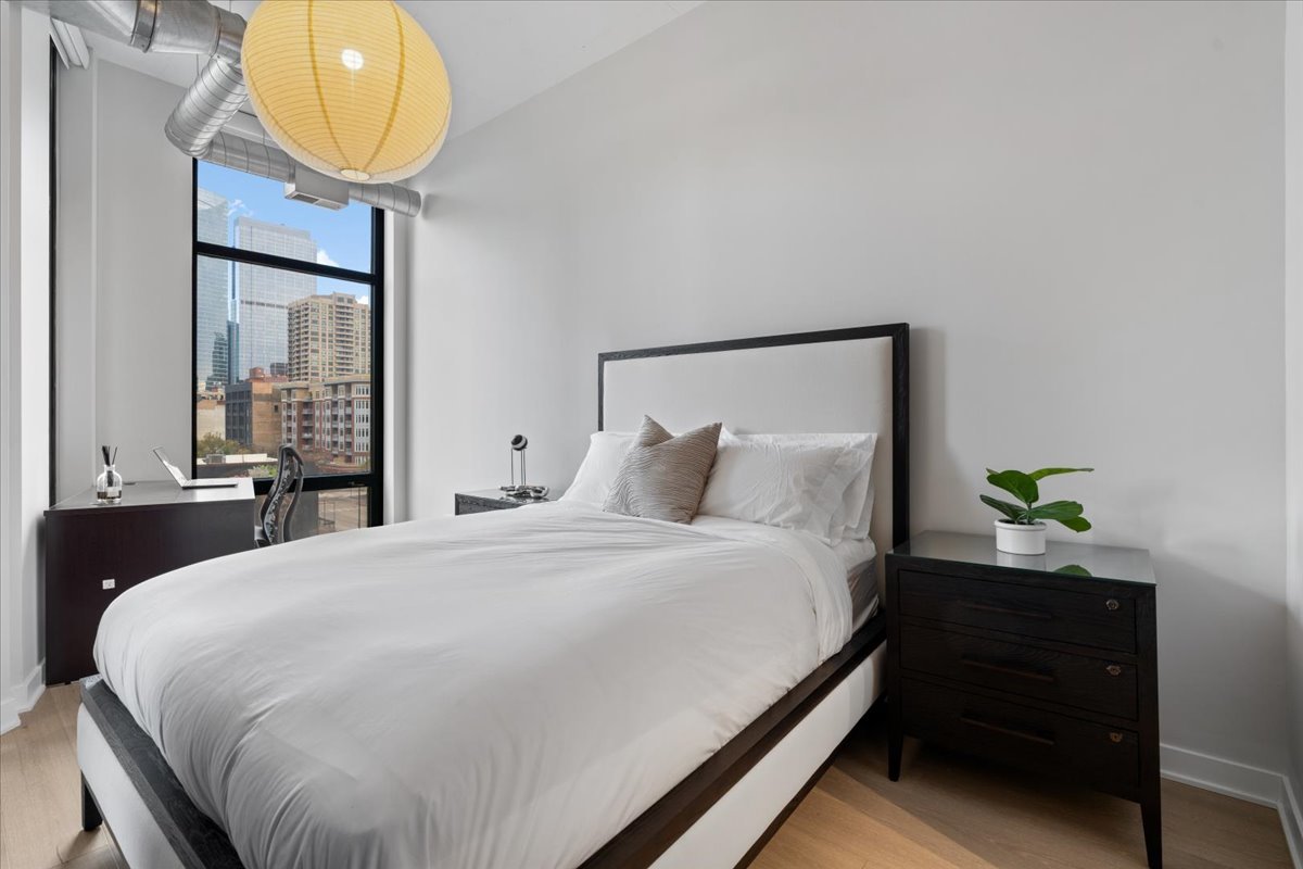 740 West Fulton Street, Unit 507 Chicago, IL 60661 - Photo 14 of 27 a bedroom with a bed and painting on the wall