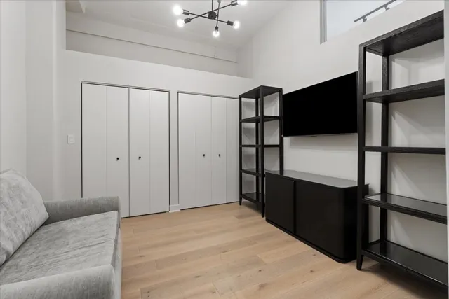 a bedroom with a bed and a glass walk in closet