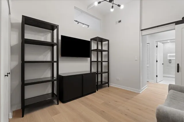 a view of empty room with wooden floor