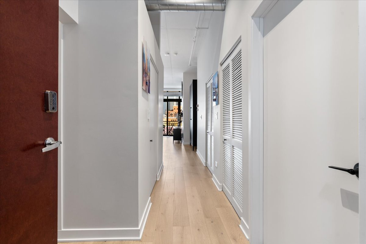 740 West Fulton Street, Unit 507 Chicago, IL 60661 - Photo 26 of 27 a view of a hallway with wooden floor and staircase