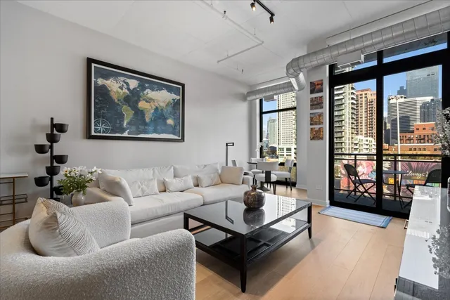 a living room with furniture and a floor to ceiling window