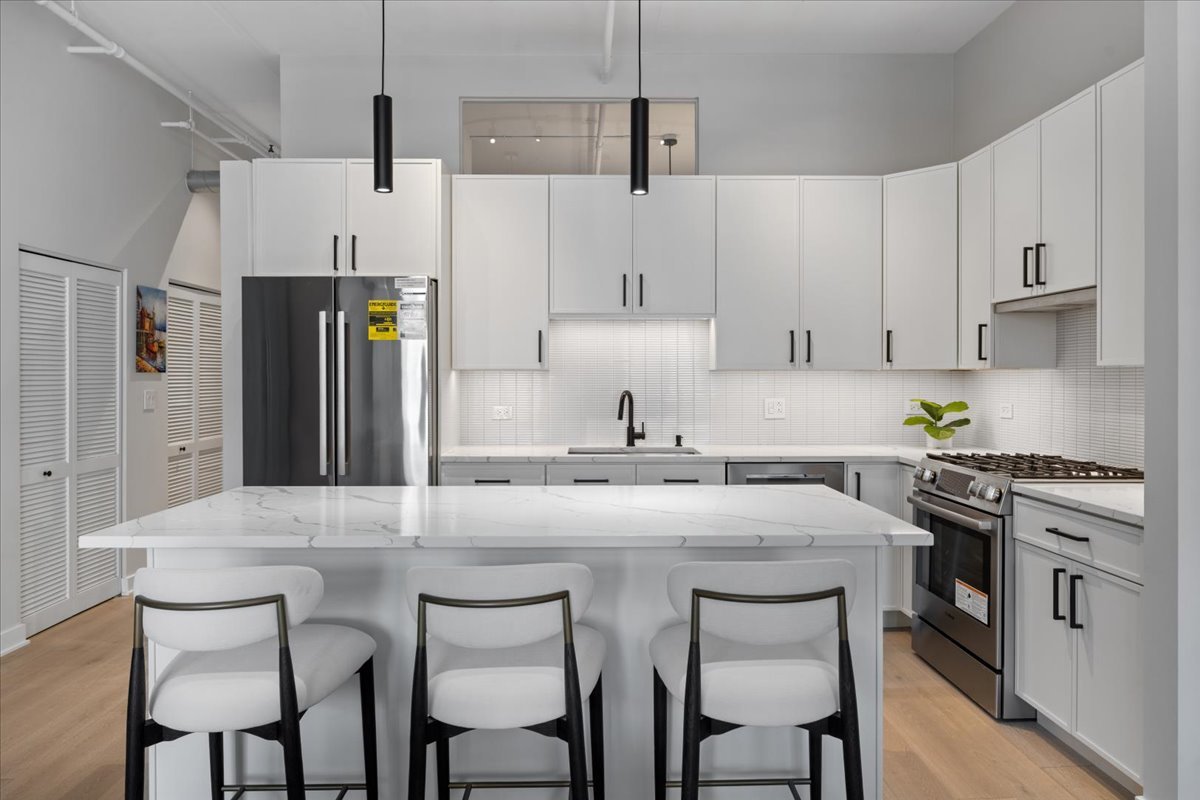 740 West Fulton Street, Unit 507 Chicago, IL 60661 - Photo 10 of 27 a kitchen with stainless steel appliances granite countertop a white cabinets and a stove