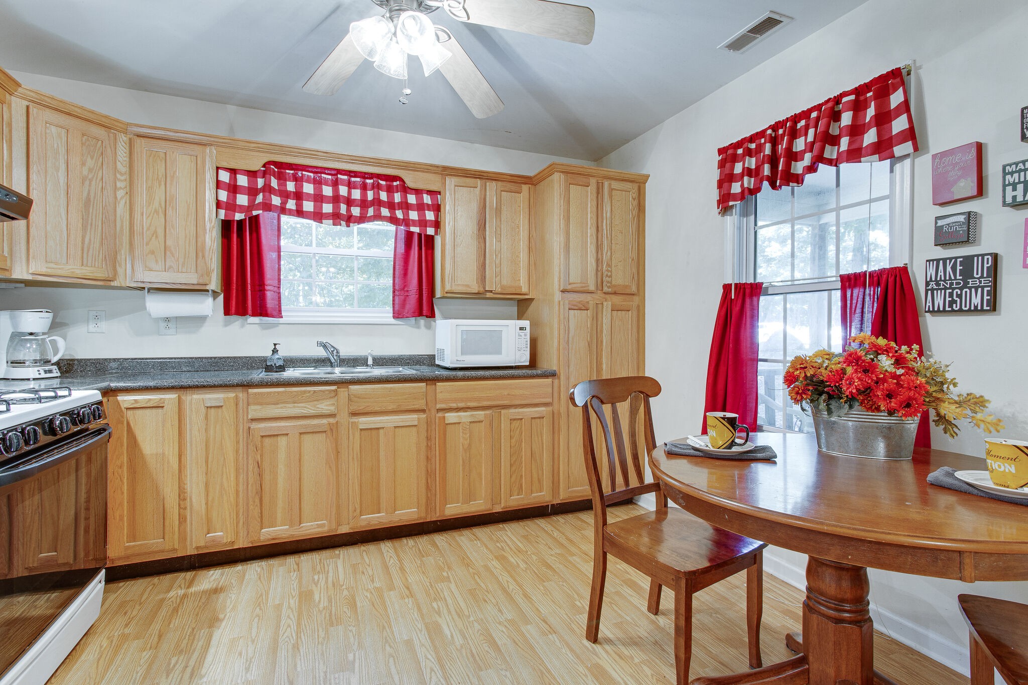 658 Cedar Mountain Place Decherd, TN 37324 - Photo 14 of 53 a kitchen with stainless steel appliances granite countertop a sink dishwasher and cabinets with wooden floor