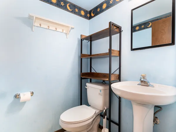 a bathroom with a sink a mirror and toilet