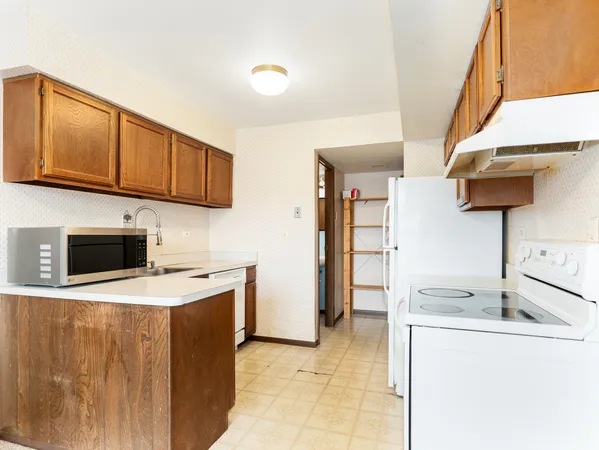 a kitchen with stainless steel appliances granite countertop a sink a stove and a refrigerator