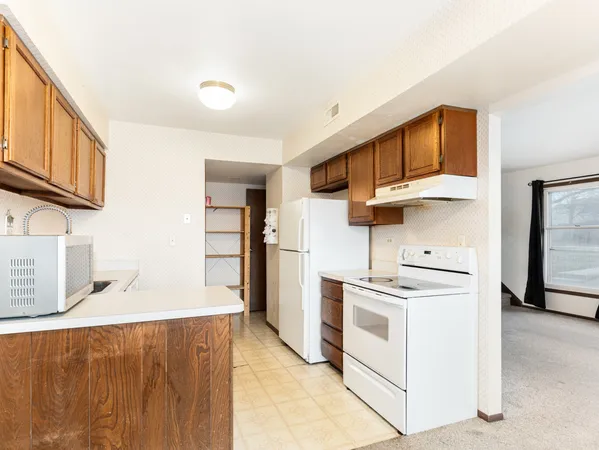 a kitchen with stainless steel appliances granite countertop a stove and a refrigerator