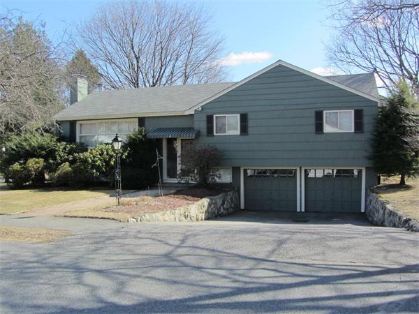 4 Oriole Road Wellesley, MA 02481 - Photo 1 of 14 a front view of a house with a yard and garage