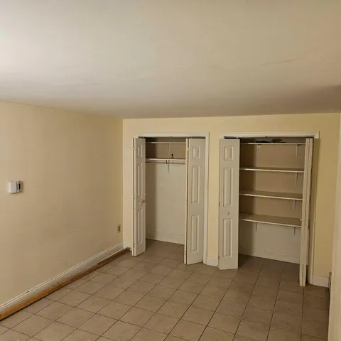 a view of an empty room and closet area