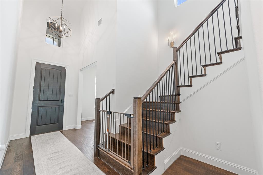5244 Ranchero Trail Fort Worth, TX 76126 - Photo 19 of 31 Foyer featuring a high ceiling, dark wood finished floors, and stairway