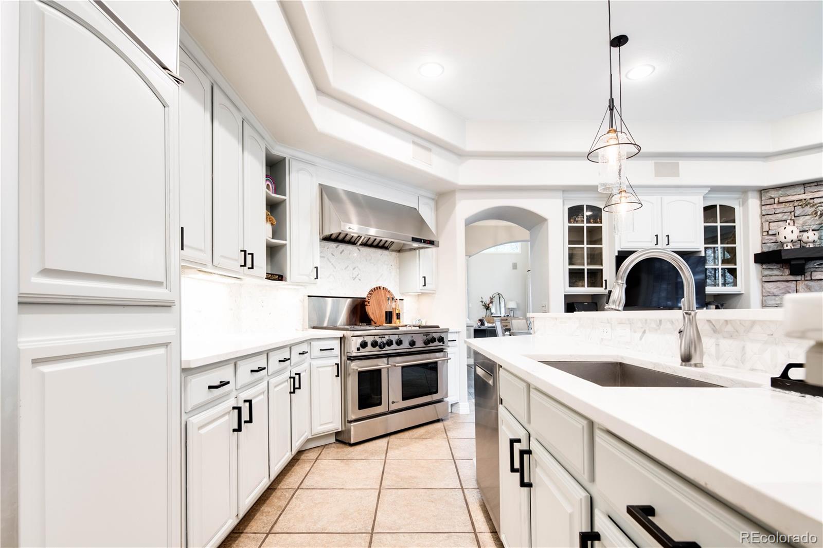1 Ravenswood Road Cherry Hills Village, CO 80113 - Photo 12 of 40 a kitchen with cabinets a sink and white appliances