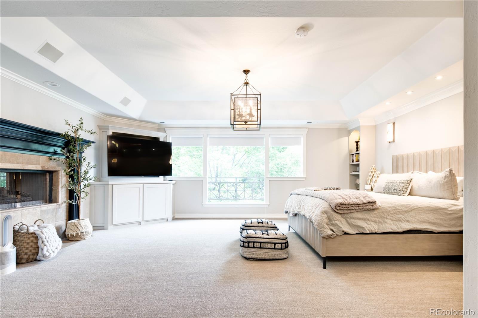 1 Ravenswood Road Cherry Hills Village, CO 80113 - Photo 20 of 40 a spacious bedroom with a bed and a flat screen tv