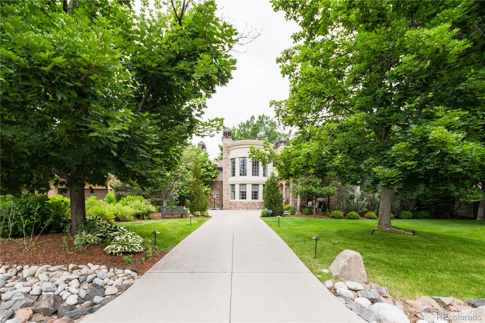 1 Ravenswood Road Cherry Hills Village, CO 80113 - Photo 2 of 40 a front view of a house with a yard